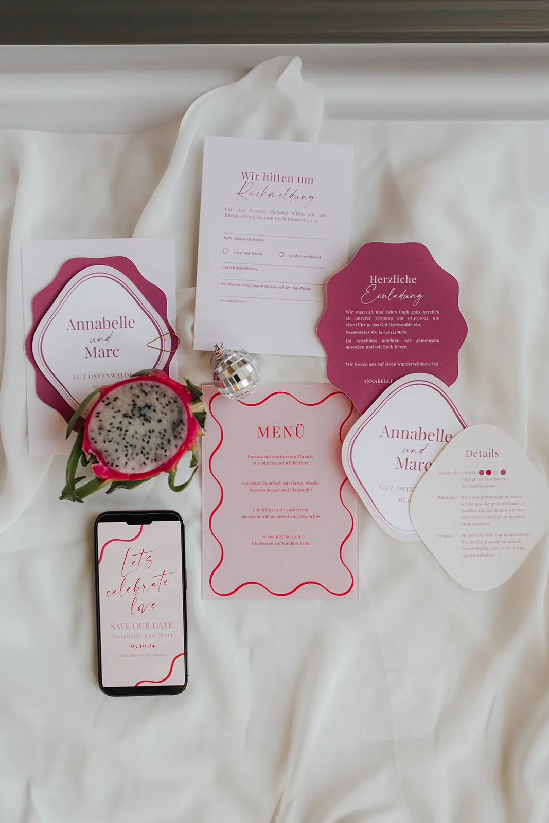 Das komplette Papeterie-Set in Pink und Beere: Einladung auf gewellter Unterlage, Antwortkarte, Detailkarte, Menükarte und digitale Save the Date